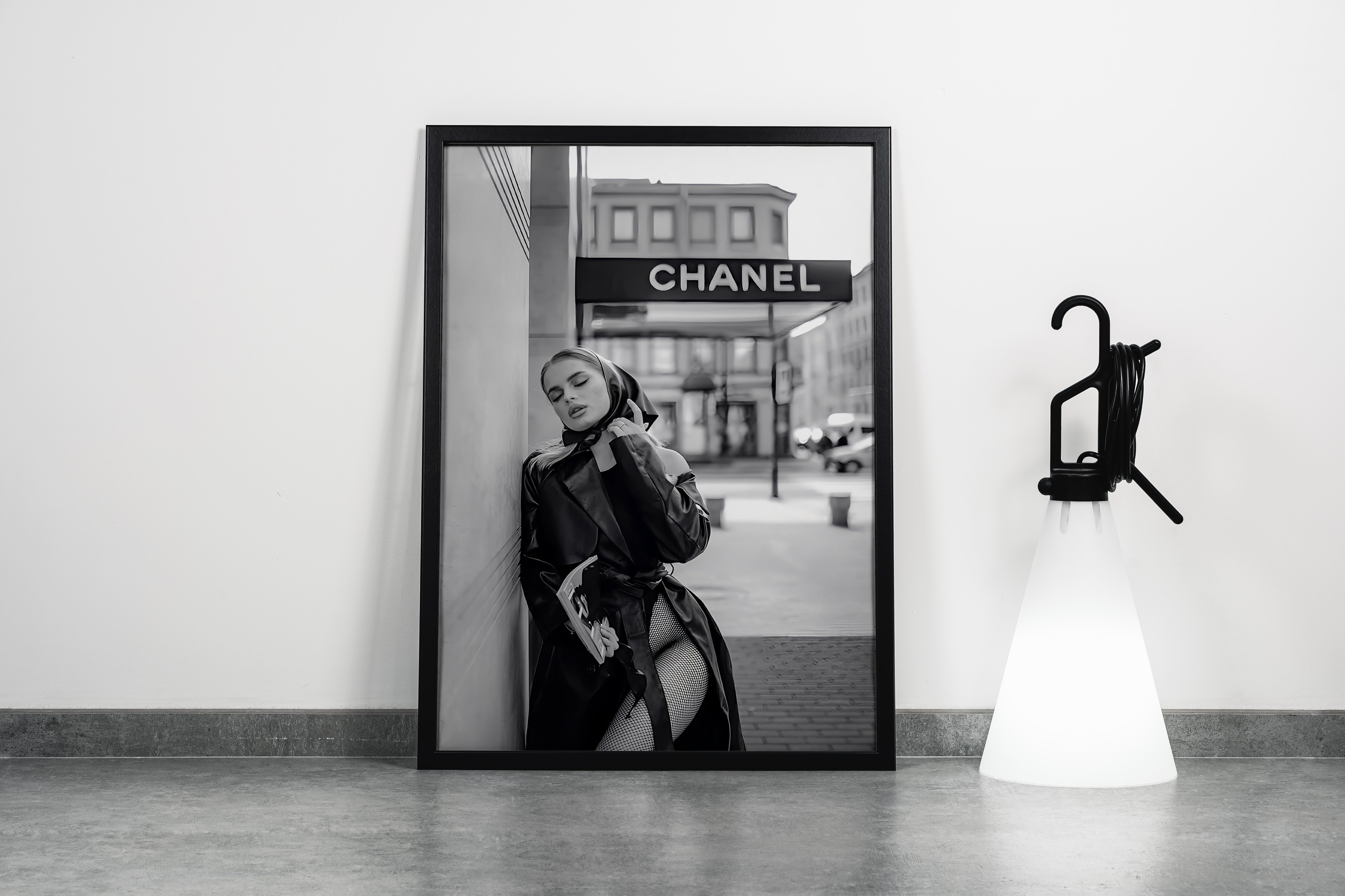 a black and white fashion photo of a woman posing under a chanel sign, art, kanvas tablo