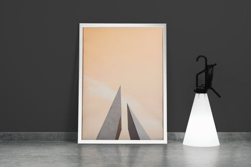 minimalist architectural photo of two sharp triangular structures against a warm pastel sky, abstract, art, kanvas tablo
